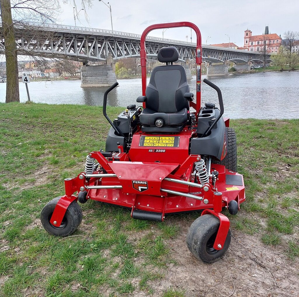 Red zero-turn mower used to collect grass clippings